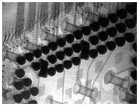 Micro BGA, rotated, reveals wire sweeps and solder ball shape.